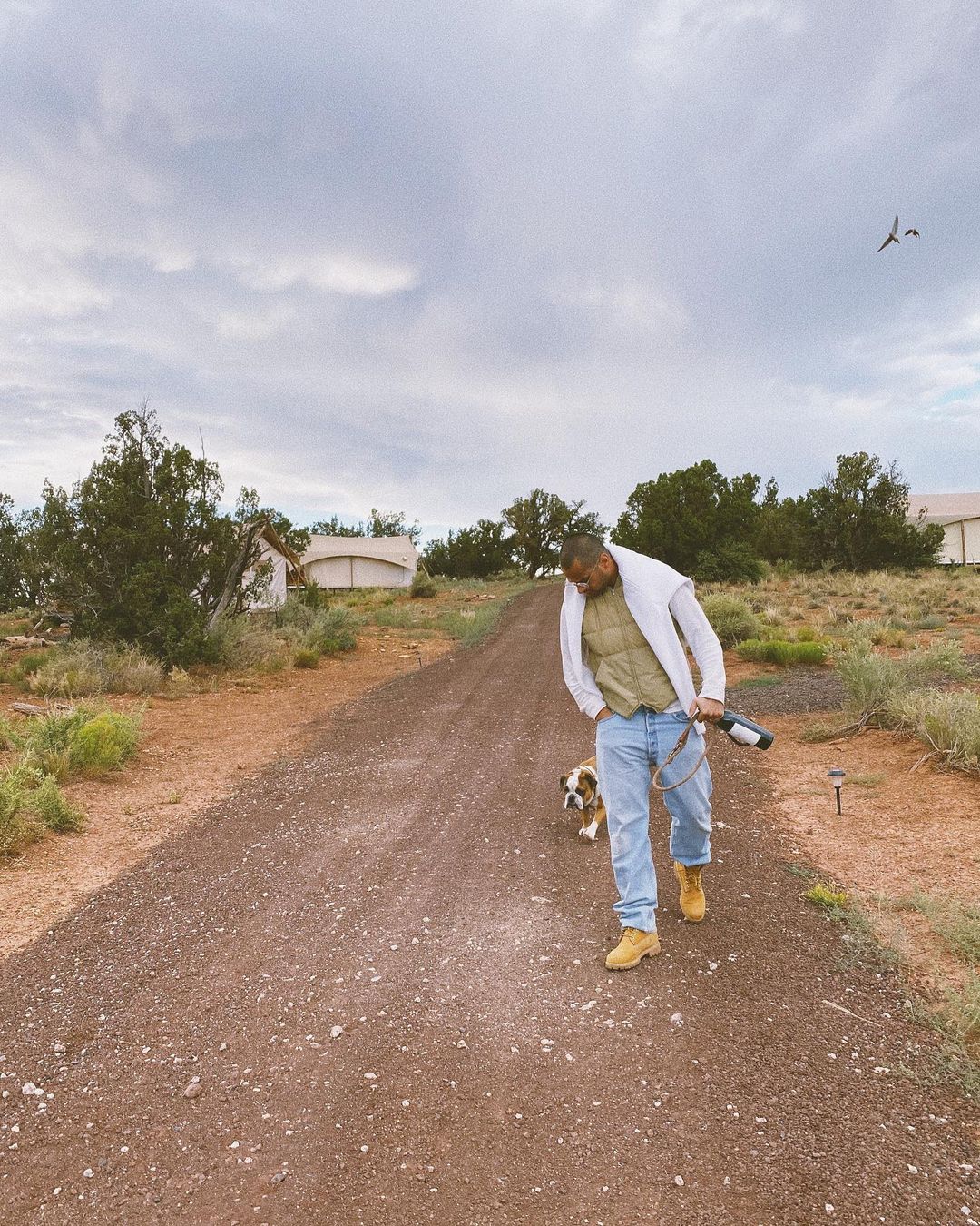 Pia Baroncini's husband Davide with dog walking on trail at Under Canvas Grand Canyon