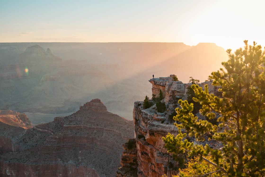 A lone hiker overlooks the Grand Canyon near the Under Canvas Grand Canyon location.