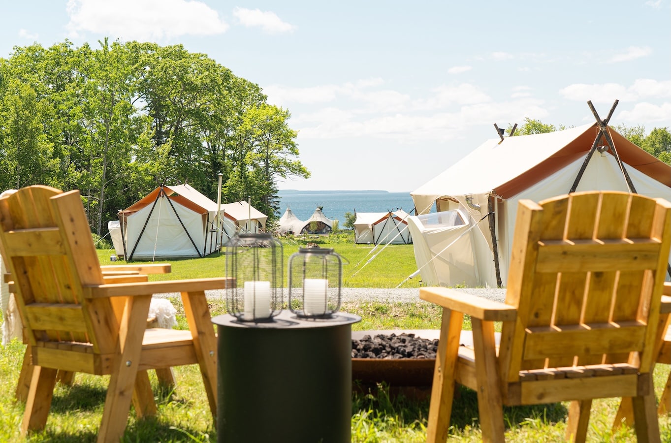 Two chairs overlooking the Under Canvas camp with the bay in the background.