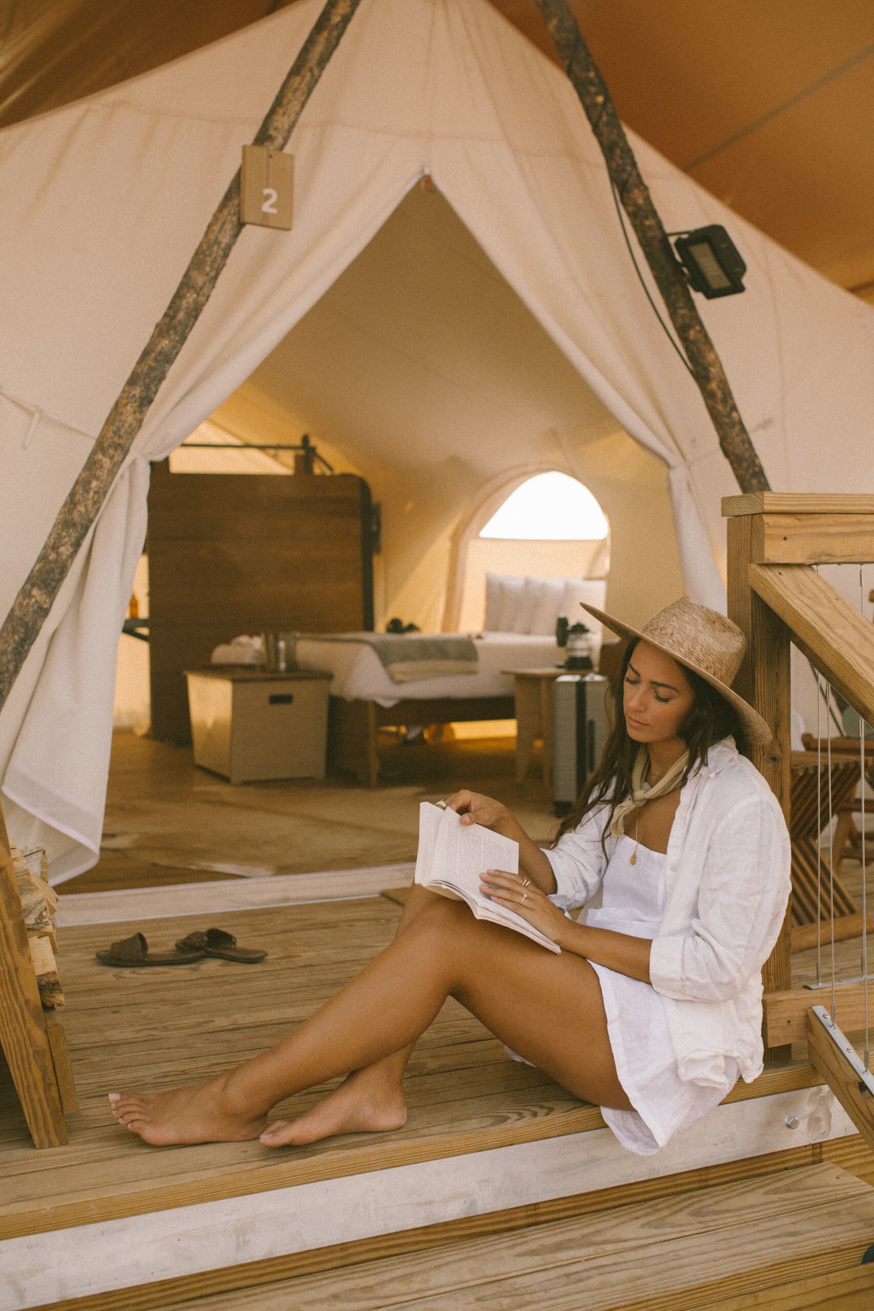 Elana Jadallah reading in her tent