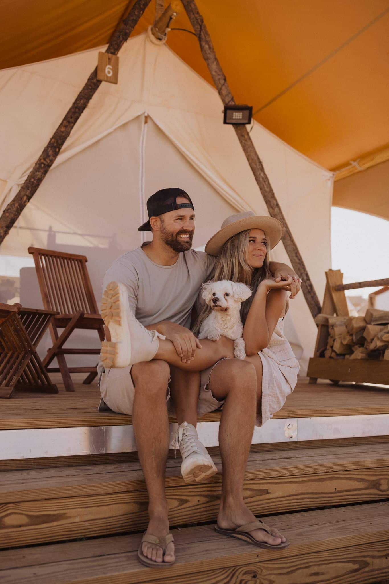Dan and Chelle with their dog on the tent deck at Under Canvas Lake Powell-Grand Staircase