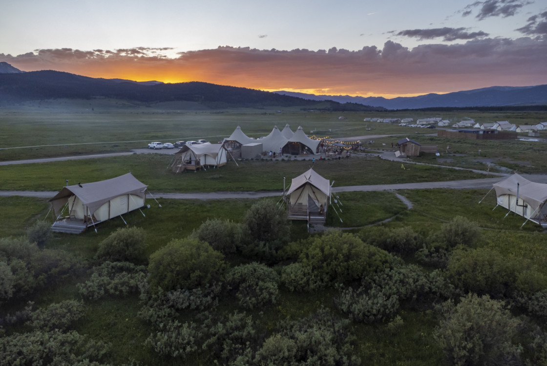 Under Canvas Yellowstone lobby with tents during sunset