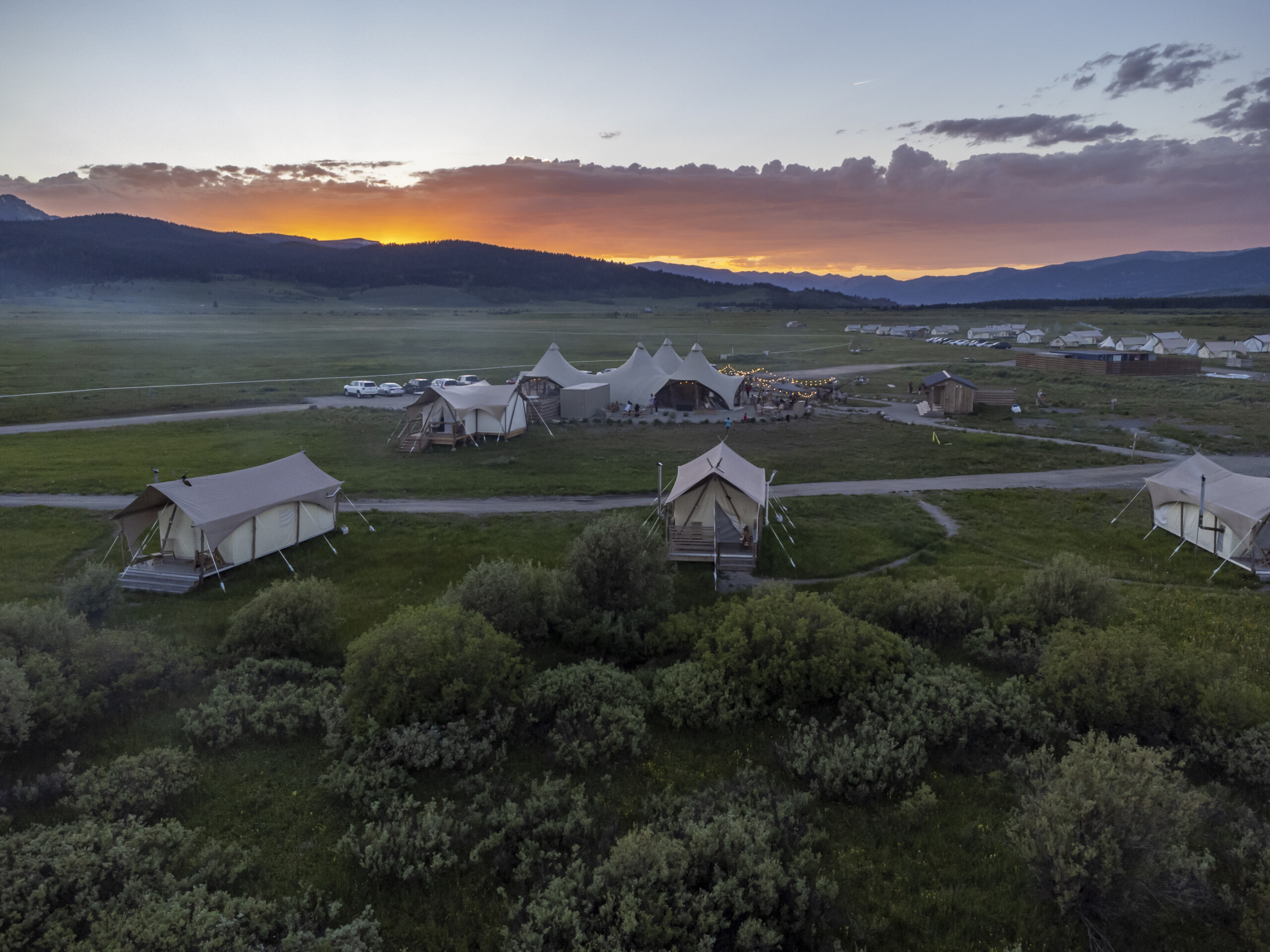 Under Canvas Yellowstone lobby with tents during sunset