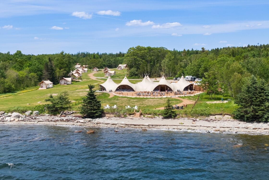 View of Under Canvas Acadia with water in the foreground.