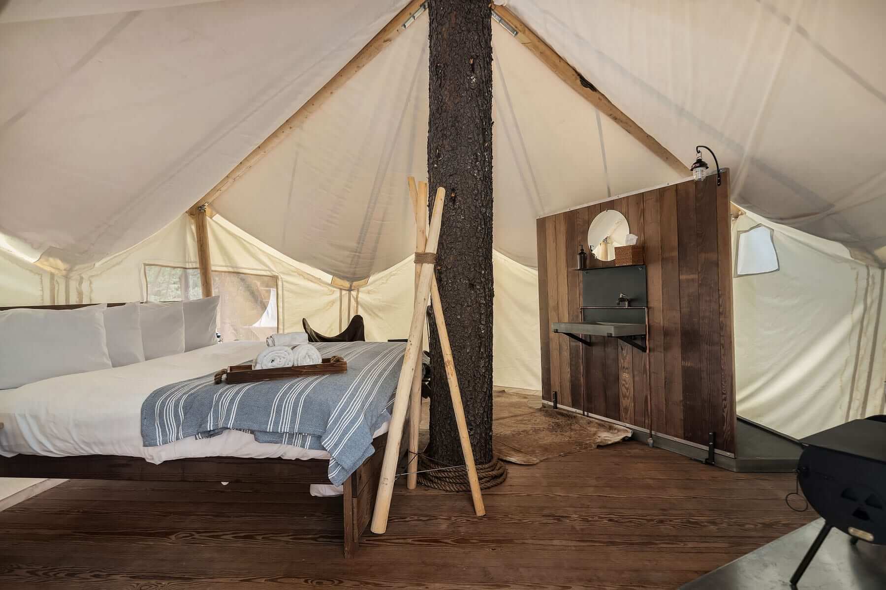 Under Canvas Glacier Canvas Tent Treehouse Interior with tree in center