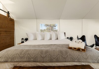 View of Bed in a Deluxe Tent at Under Canvas Bryce Canyon