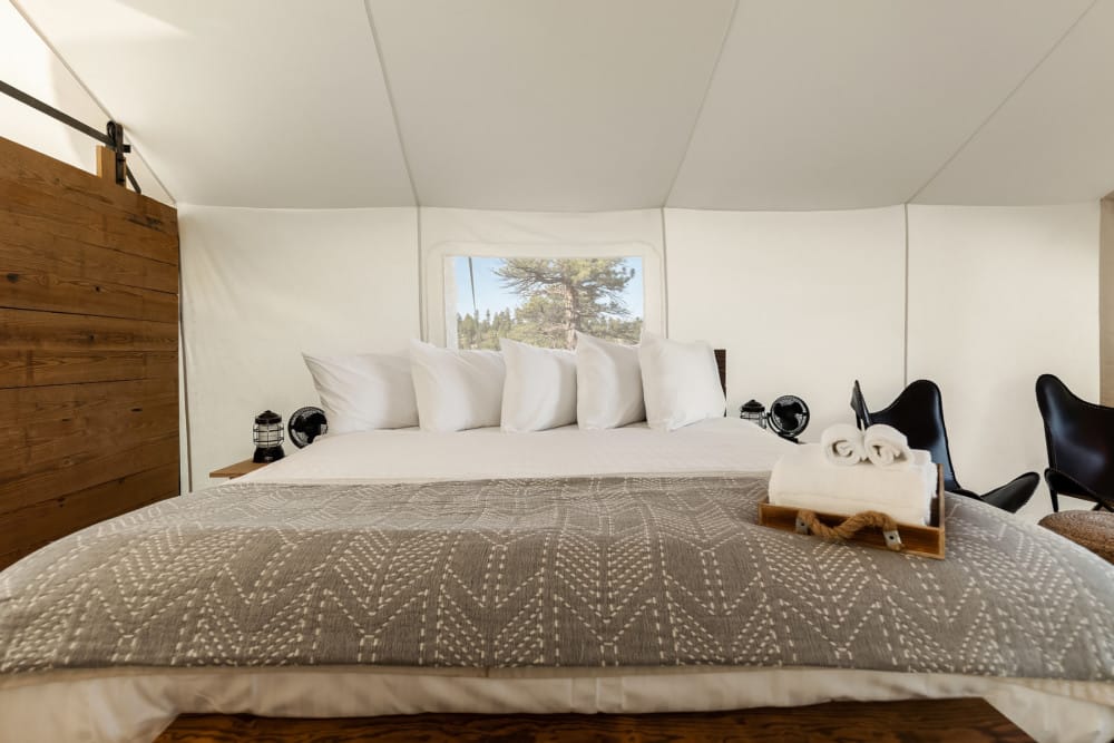 View of Bed in a Deluxe Tent at Under Canvas Bryce Canyon
