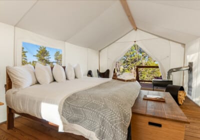 View of Bed in a Deluxe Tent at Under Canvas Bryce Canyon