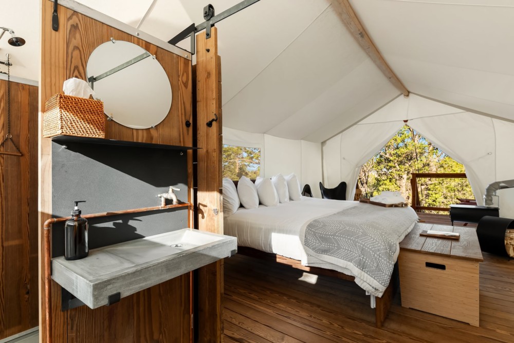 View of Bathroom Sink and Bed in a Deluxe Tent at Under Canvas Bryce Canyon