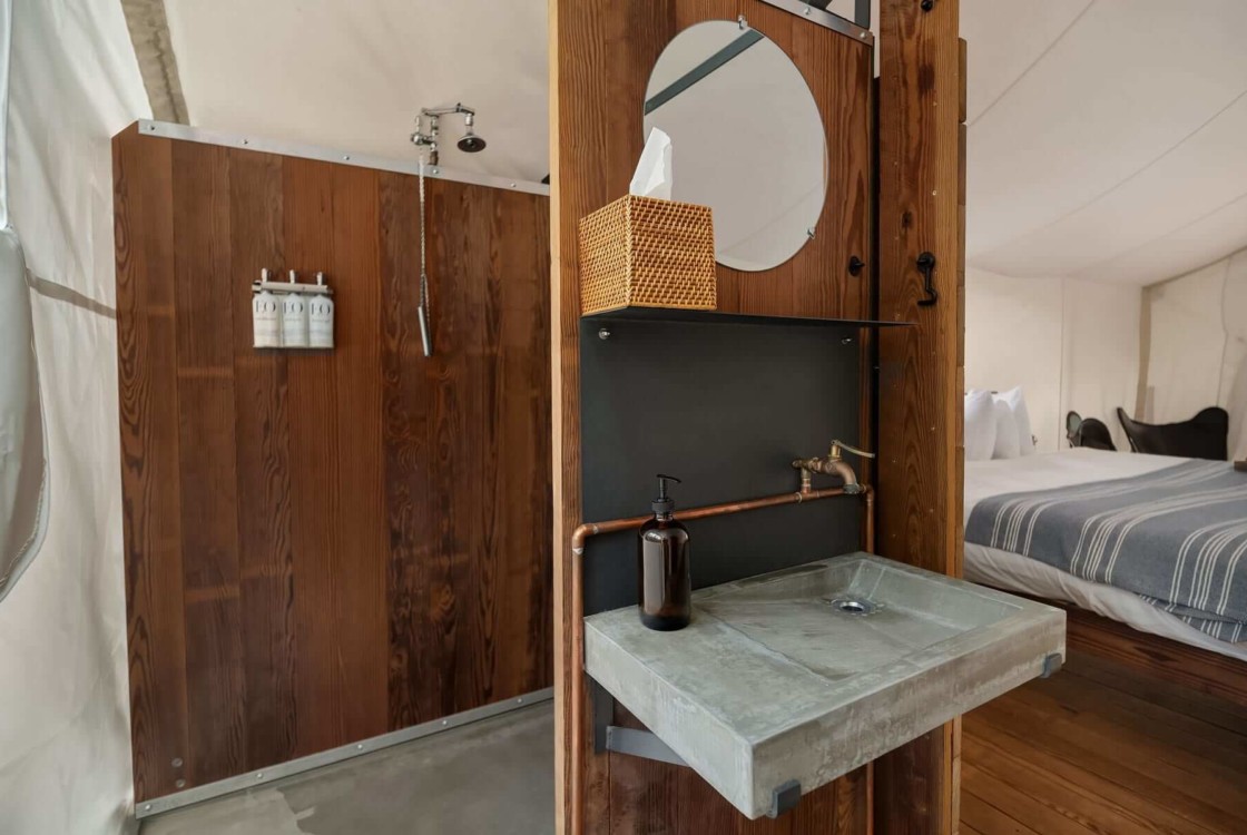 Under Canvas Glacier Deluxe Tent Interior with view of bathroom