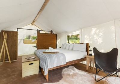 View of Bed in a Deluxe Tent Under Canvas Glacier