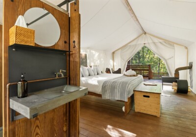 View of Bathroom Sink and Bed in Deluxe Tent Under Canvas Glacier