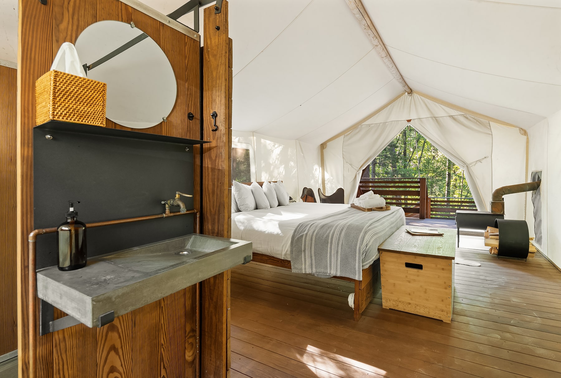 View of Bathroom Sink and Bed in Deluxe Tent Under Canvas Glacier