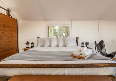 View of Bed in a Deluxe Tent at Under Canvas Grand Canyon