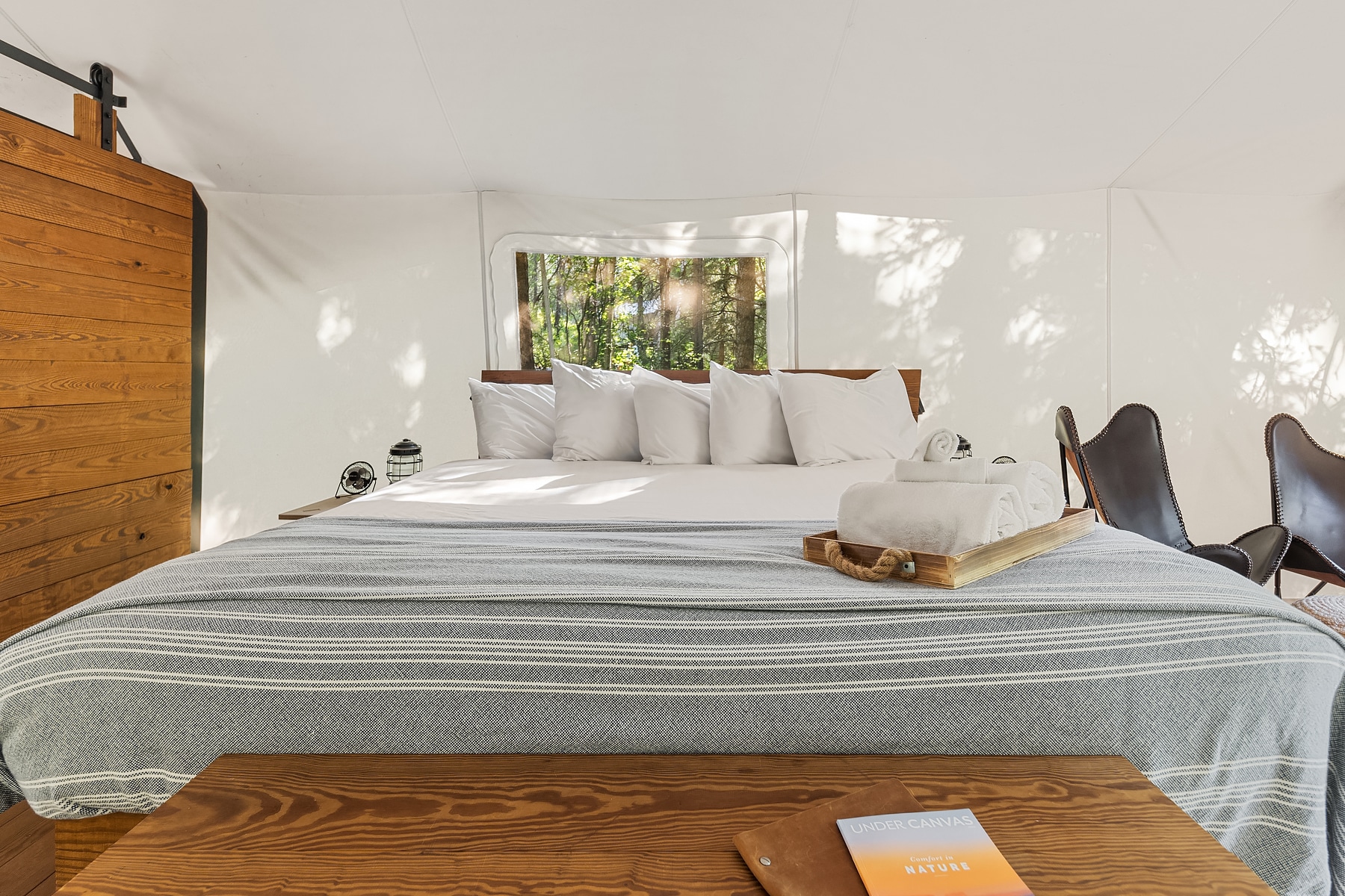 View of Bed in Deluxe Tent at Under Canvas Glacier
