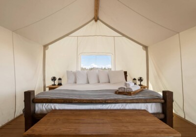 View of King Bed in Suite Tent at Under Canvas Grand Canyon