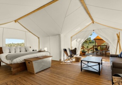 Hoodoo Suite Interior with view of deck and adjoining tent at Under Canvas Bryce Canyon