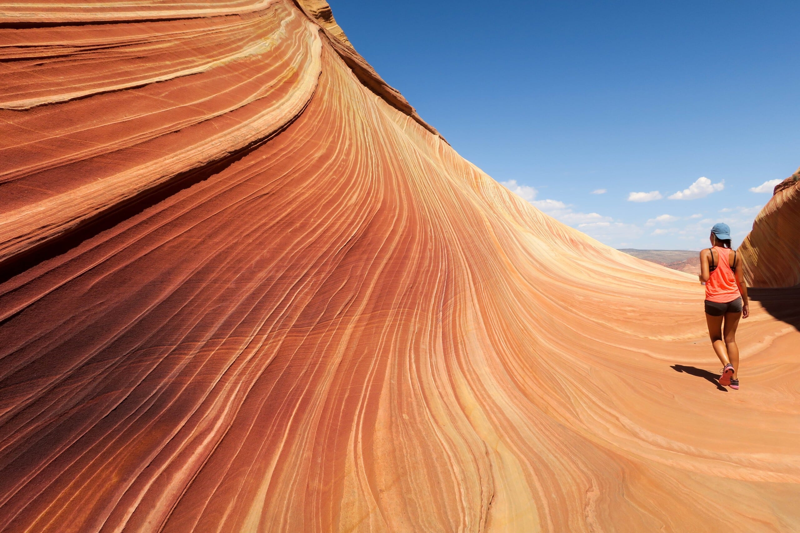 Woman walking on The Wave in Grand Staircase-Escalante