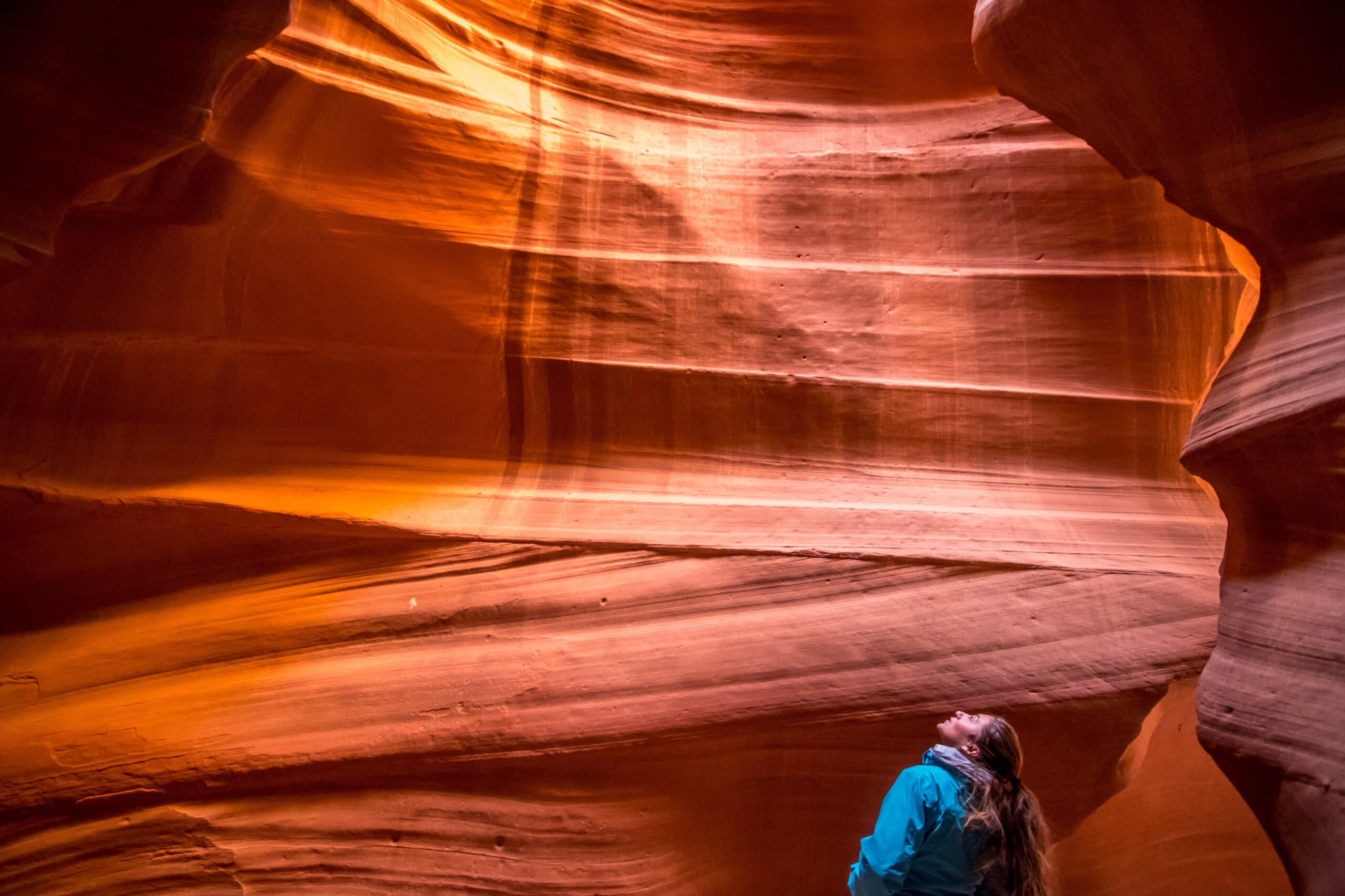Woman staring up at sky in Antelope Canyon