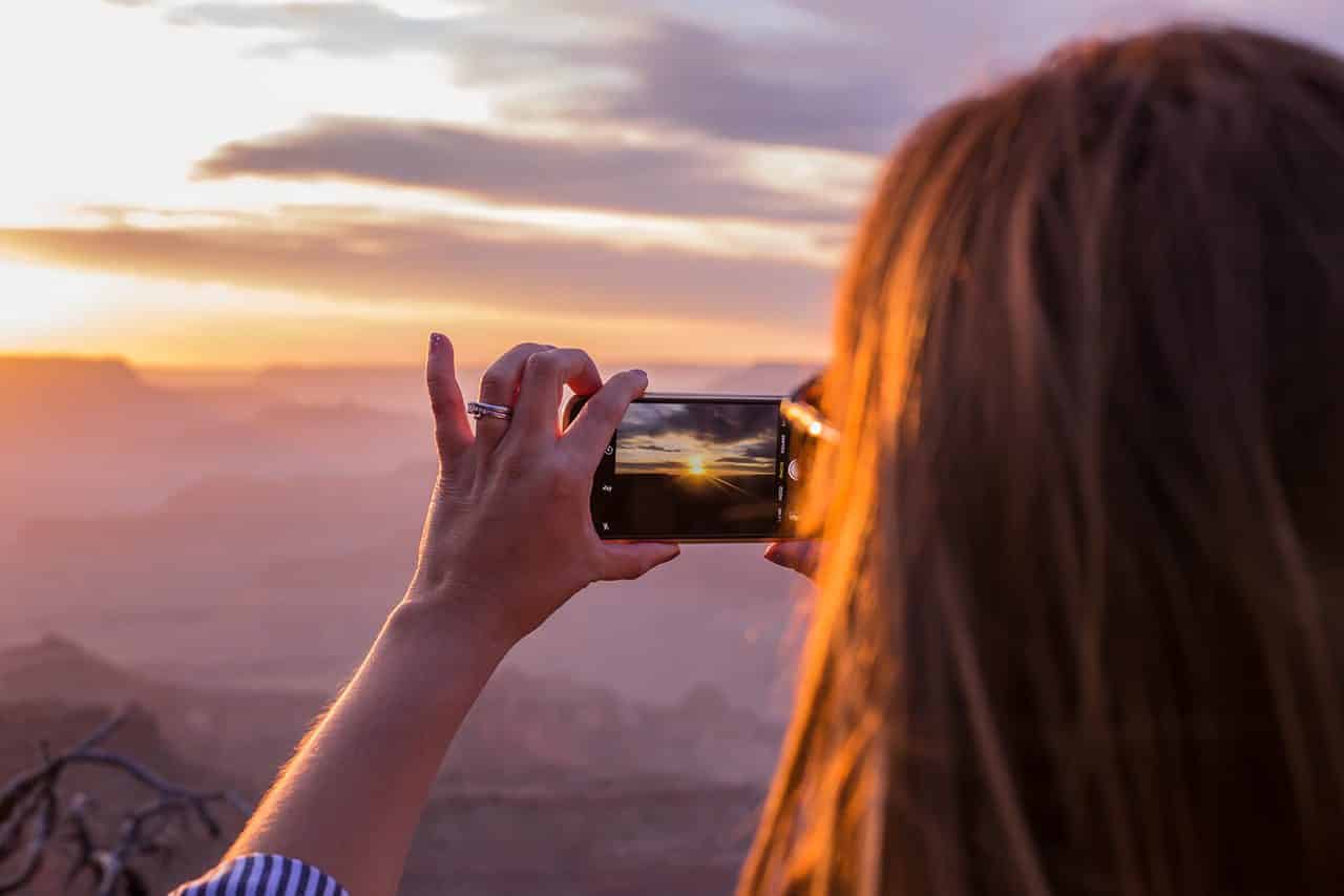 Person taking a photo of beautiful sunset