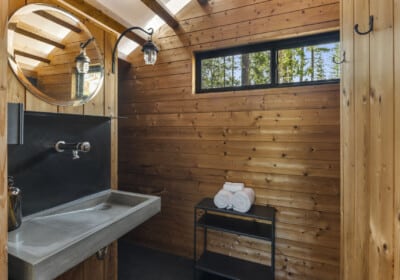 bathroom sink with mirror and window interior with wood panels