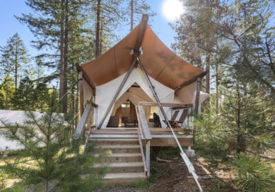 exterior of canvas tent with private deck surrounded by trees
