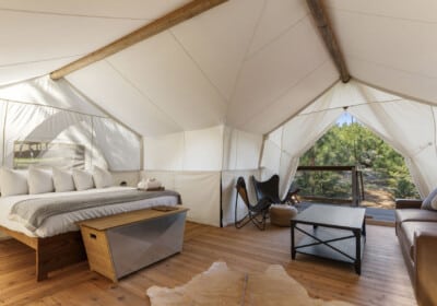 king bed in canvas tent with seating area