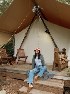 Laura Jung on deck of Deluxe Tent at Under Canvas Acadia