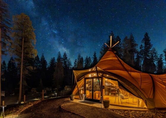 Under Canvas Yosemite lobby tent at night.
