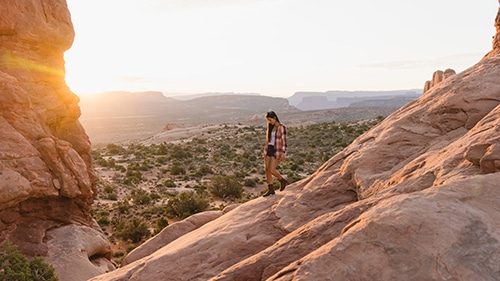 Arches National Park girl hiking on rocks