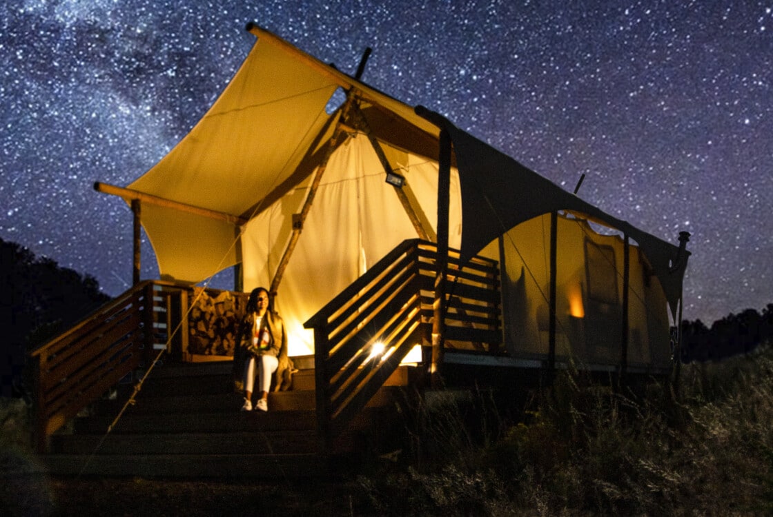 Woman stargazing at Under Canvas Grand Canyon