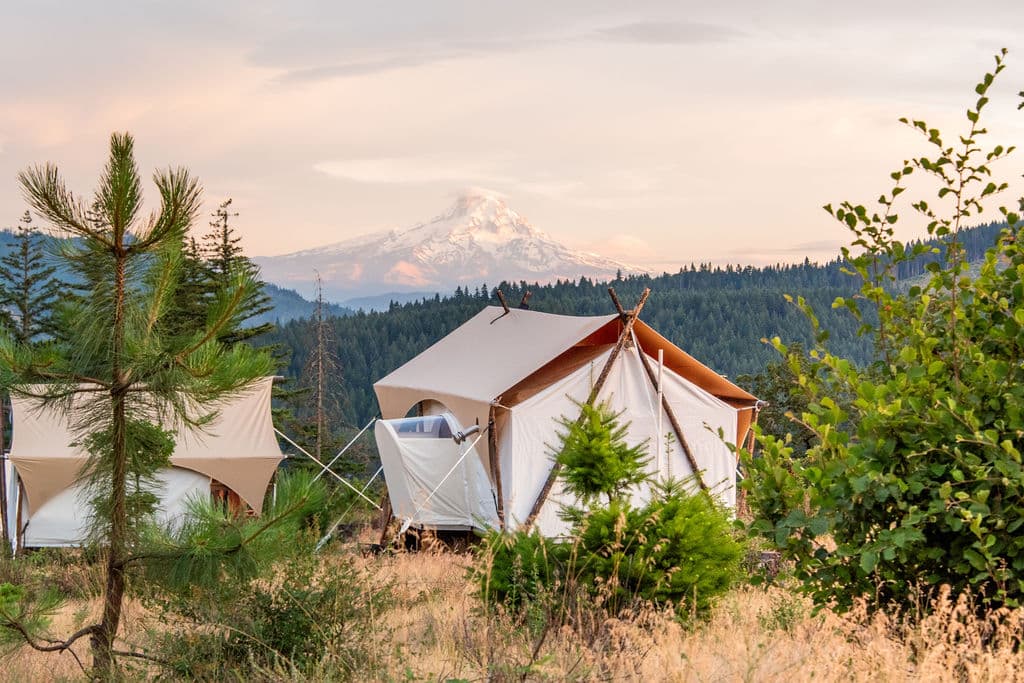 View of a stargazer tent at Under Canvas Columbia River Gorge with Mt. Hood in the background.