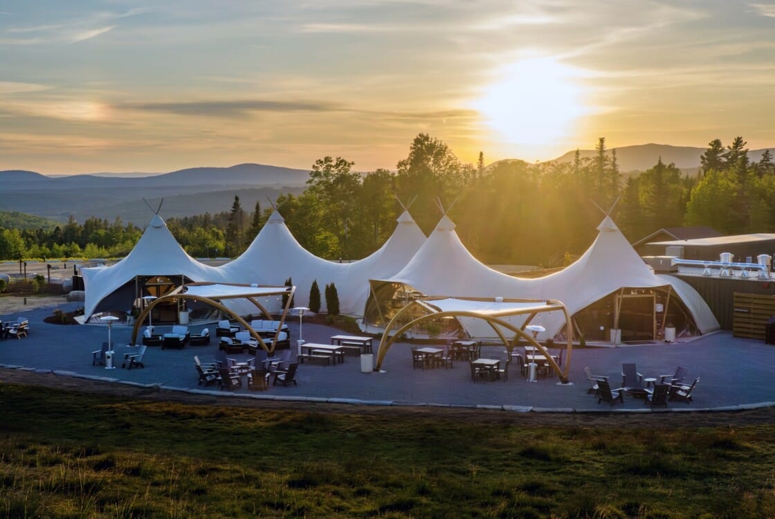 Lobby tent at Under Canvas White Mountains during sunset.