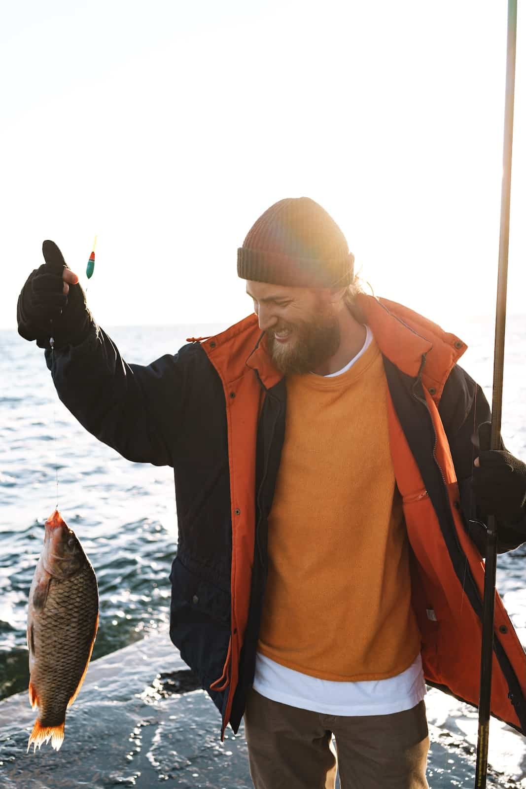 Man holding up a fish he just caught.