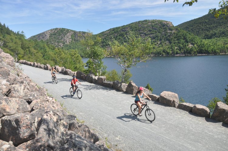 Group of bikers by a lake in Acadia National Park