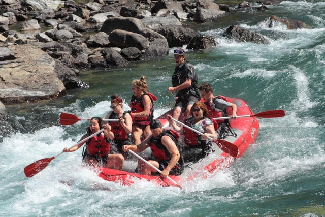 Group of rafters going through a rapid.