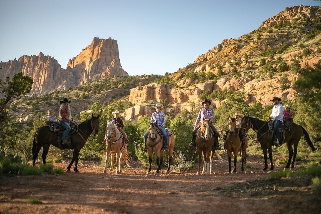 Horseback riders near a canyon.