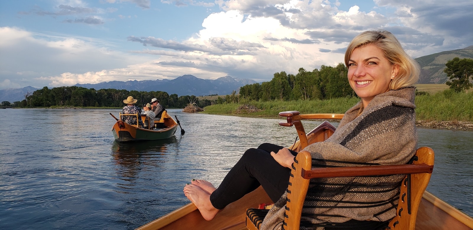 Woman on a wooden canoe floating the Yellowstone River.
