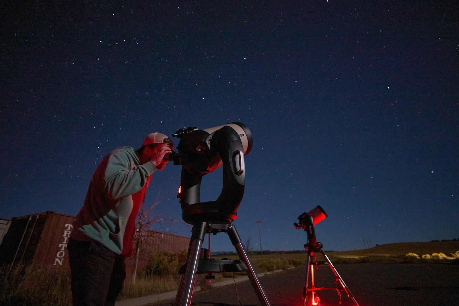Person looking through a telescope while they stargaze near Bryce Canyon.