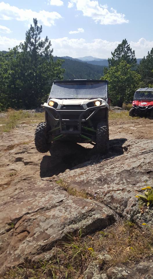 UTV in the Black Hills of South Dakota going over rocks.