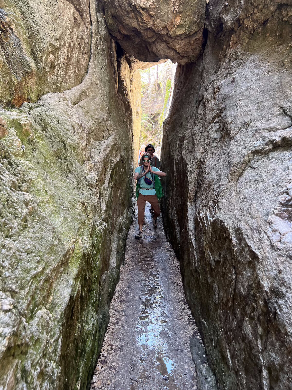 People hiking in a narrow chute of the black hills.