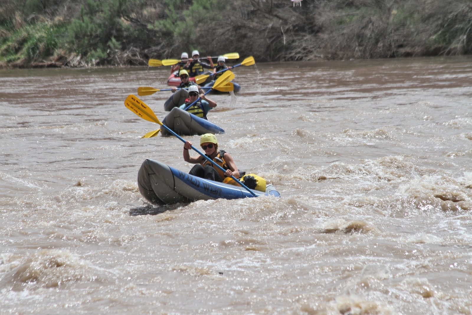 Group of kayakers in white water near Moab.