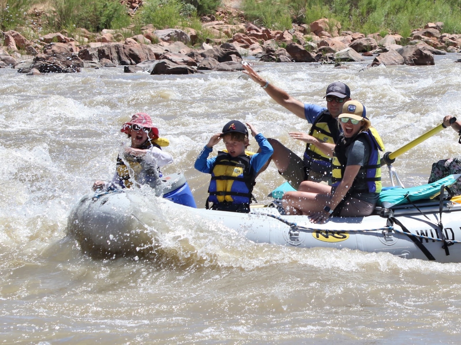 Happy family white water rafting.