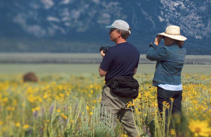 People taking pictures and sightseeing in Yellowstone.