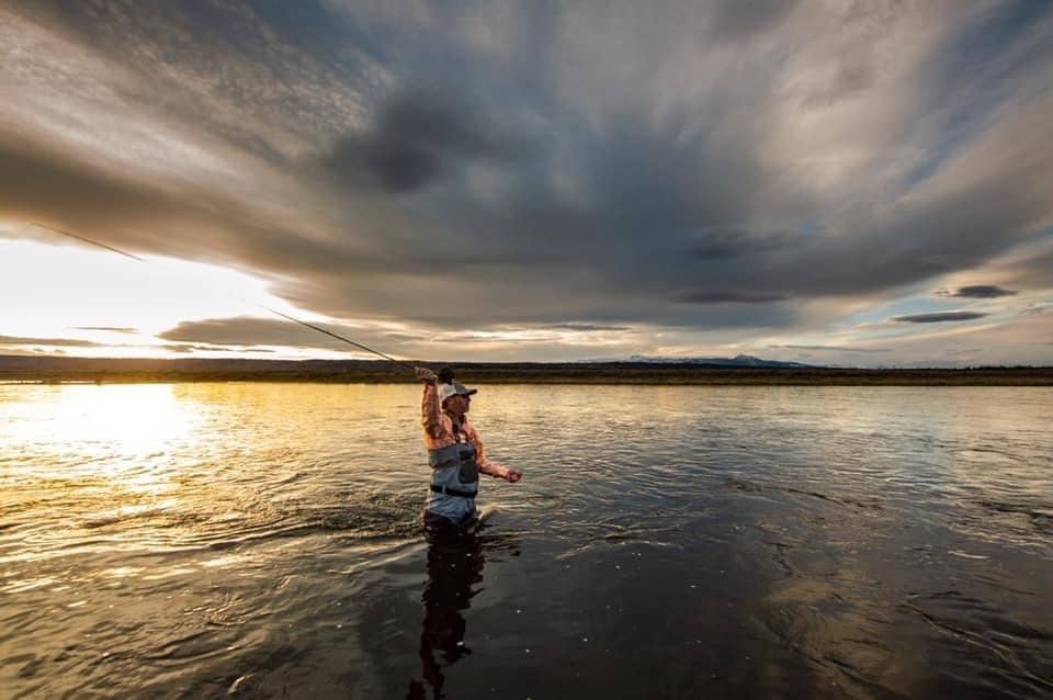 Man fly fihsing in a lake near Yellowstone.