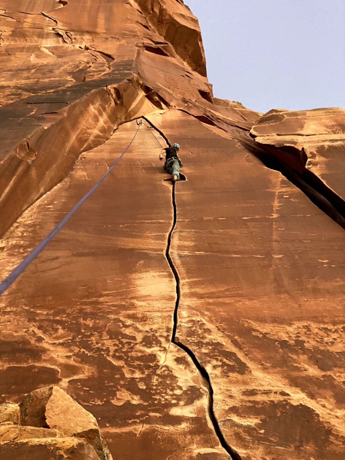 Person climbing up a crack in rock