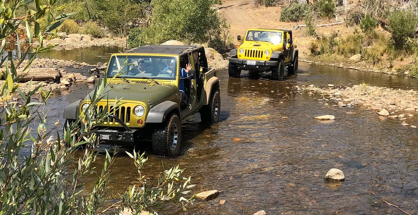 Jeeps crossing a creek bed in Stanislaus National Forest.