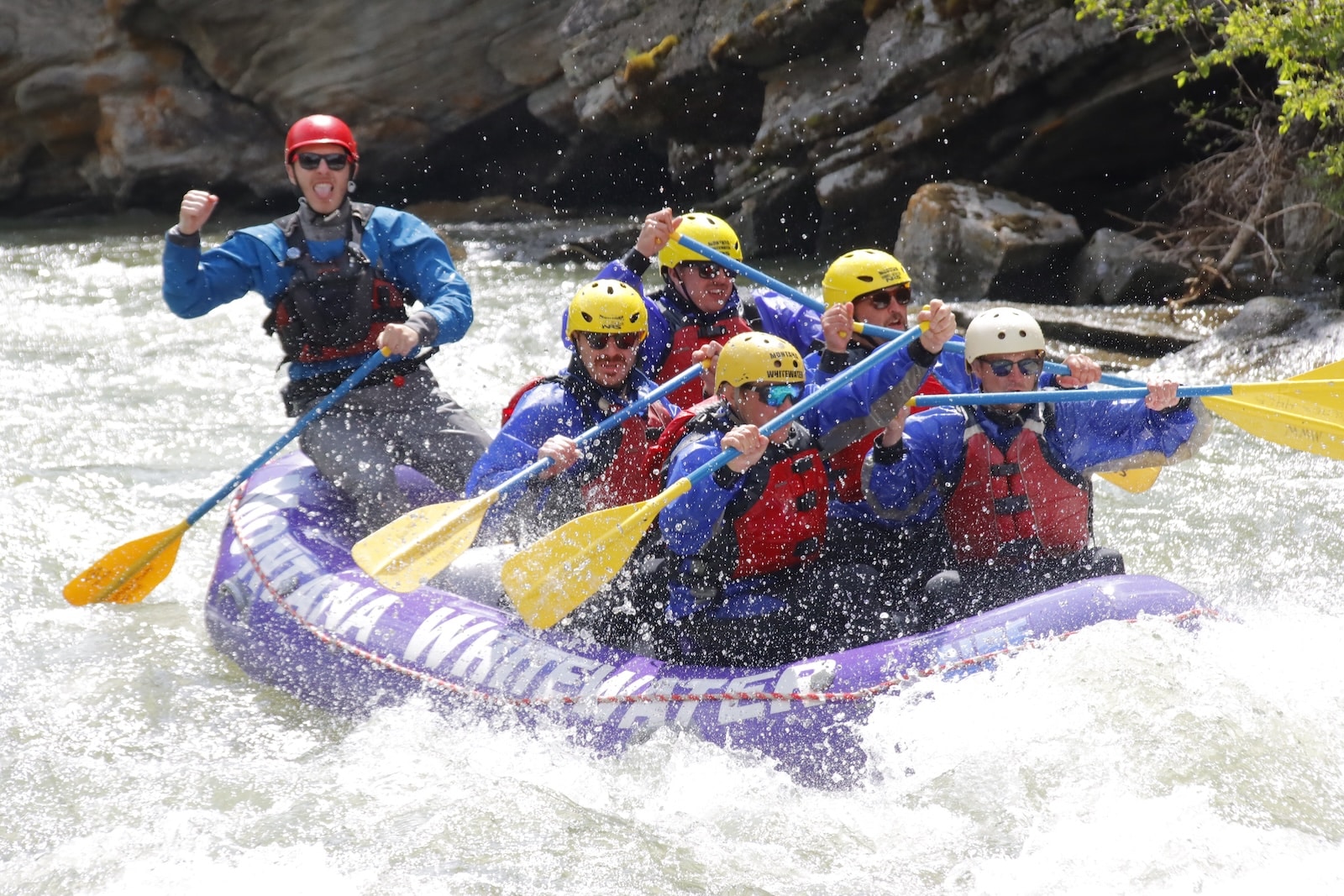 White water rafters going through a canyon.