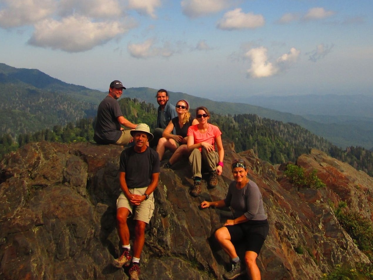 Family sitting on top of mountain in Great Smoky Mountain National Park.