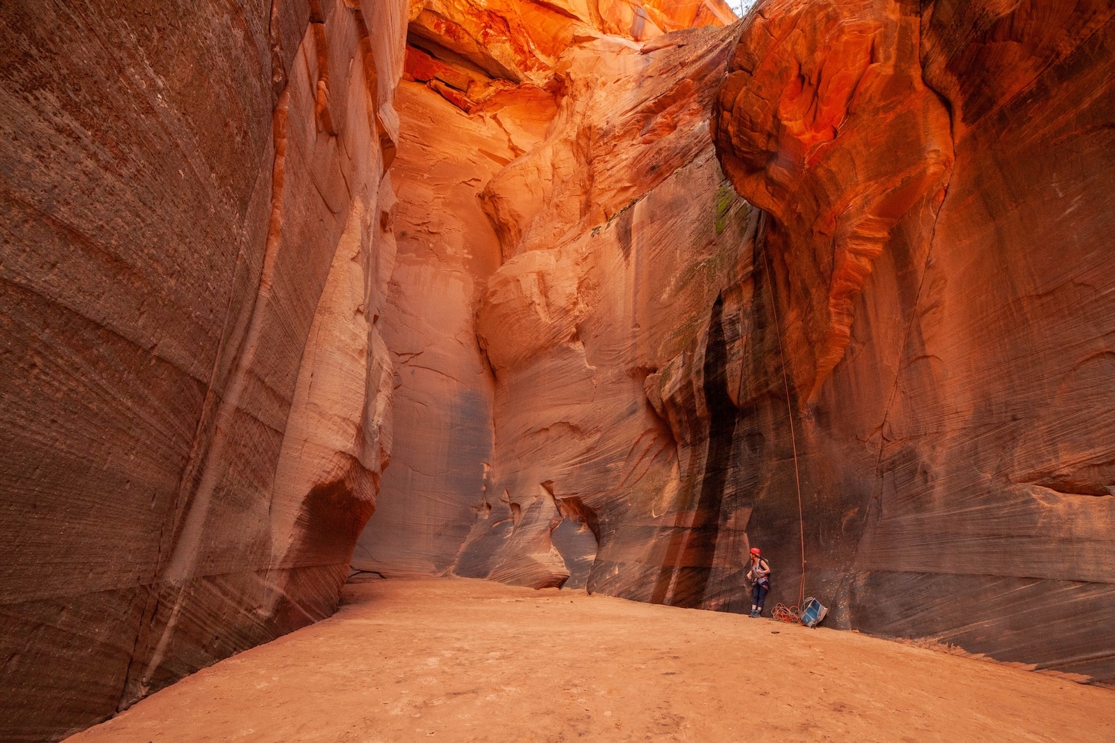 Person finishing a rappel down Rock Canyon.